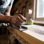 carpenter-cutting-mdf-board-inside-workshop